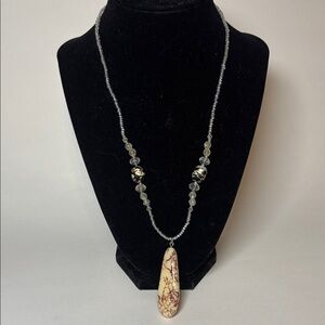 Cream Colored Teardrop 2” Pendant on a 20” clear beaded necklace